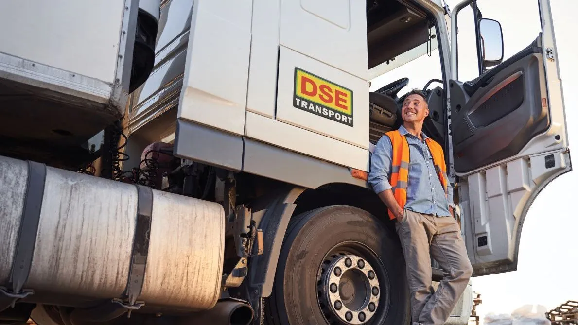 A DSE Transport worker in an orange safety vest
