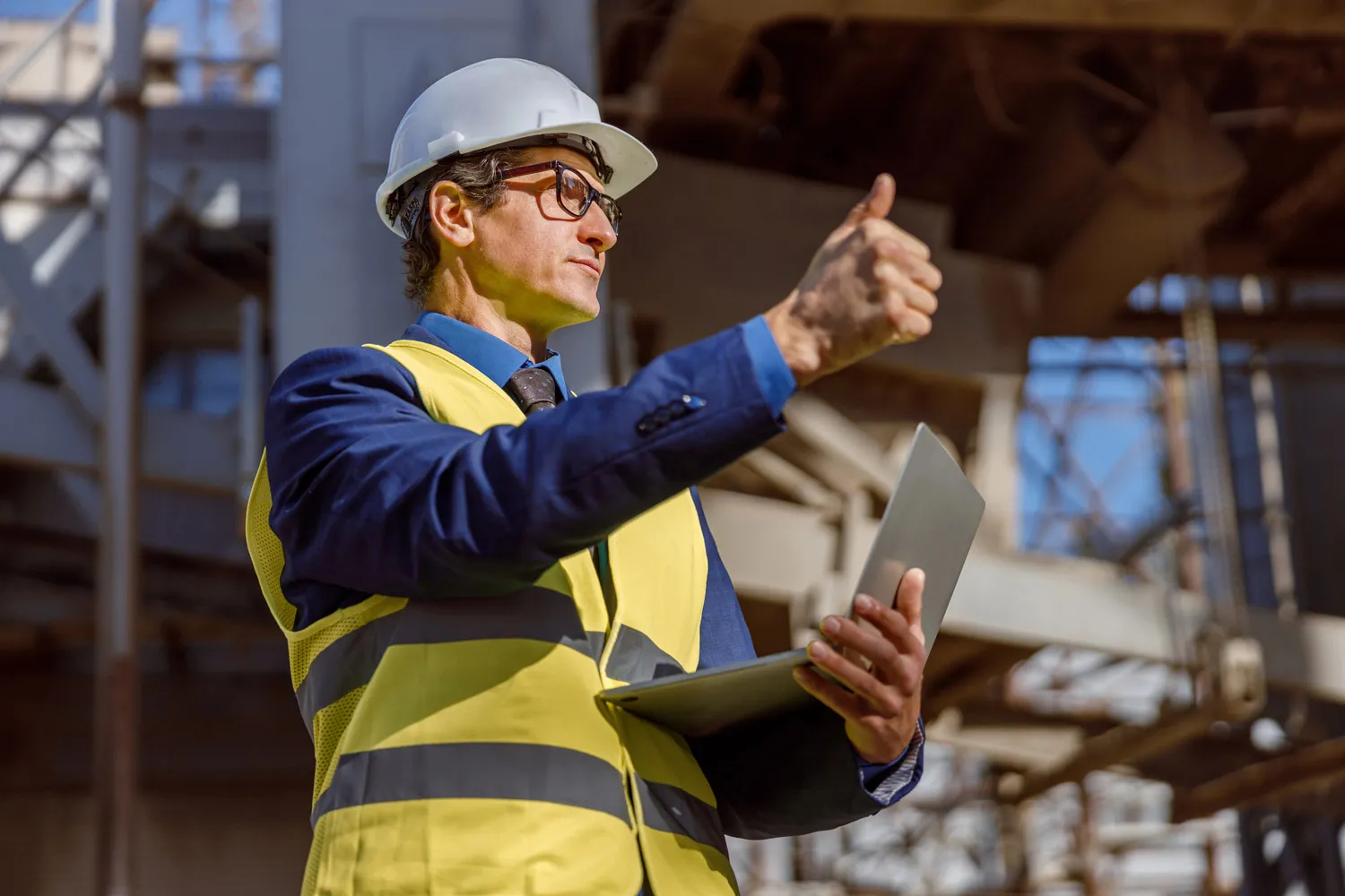 A construction site manager giving a thumbs-up