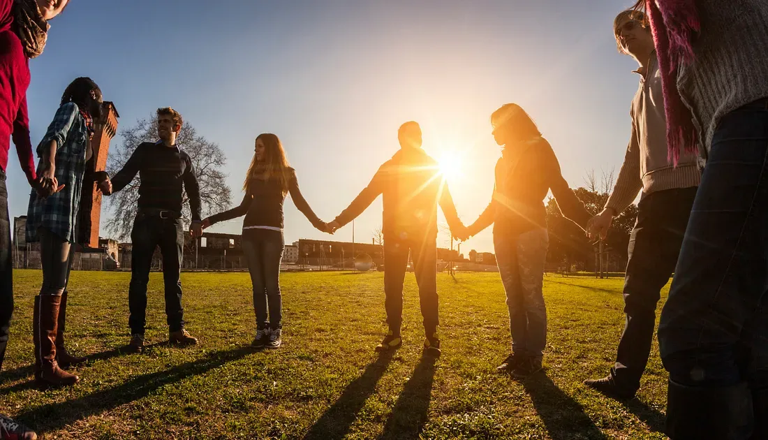 a group of people holding hands