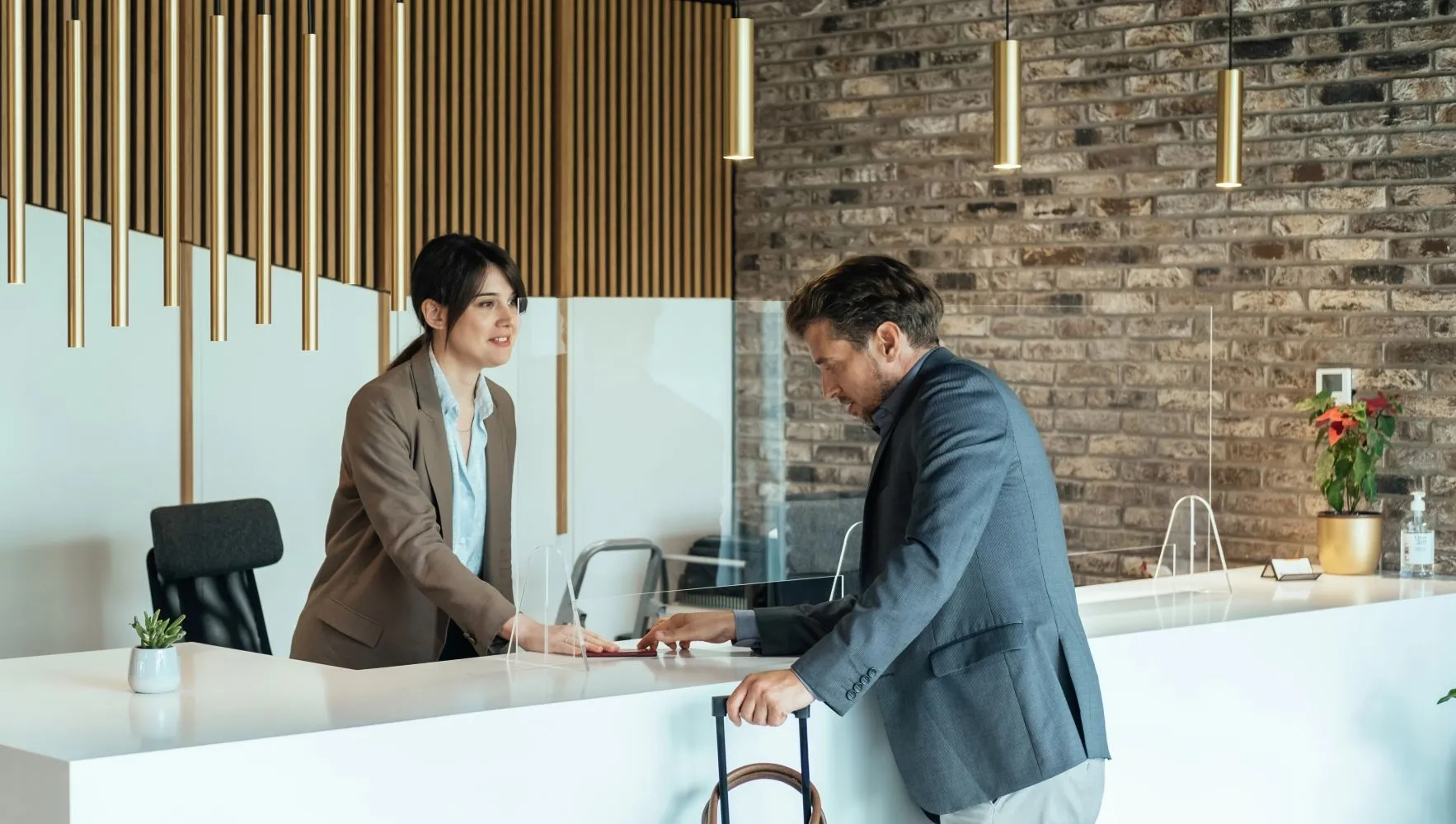 Businessman signing in at a reception desk