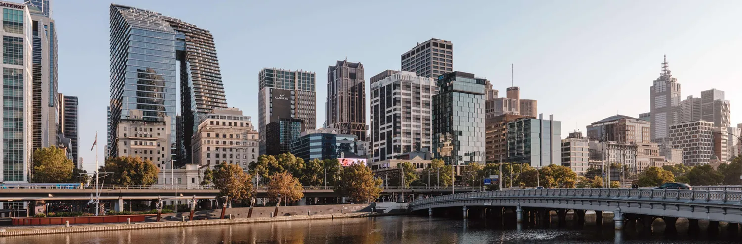 A photograph of the Melbourne city skyline, looking north across the Yarra River