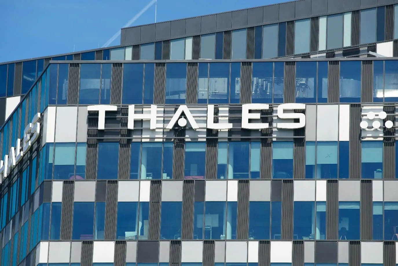 Grey warship with blue sky in background. Image represents how Thales Group managed contractor onboarding.