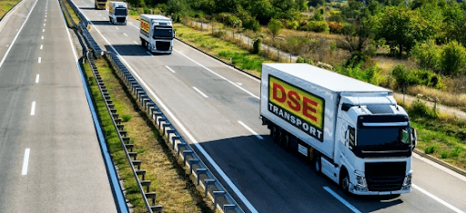 A convoy of white trucks with yellow and red DSE logos. The image represents DSE's improvements to worker induction and onboarding.