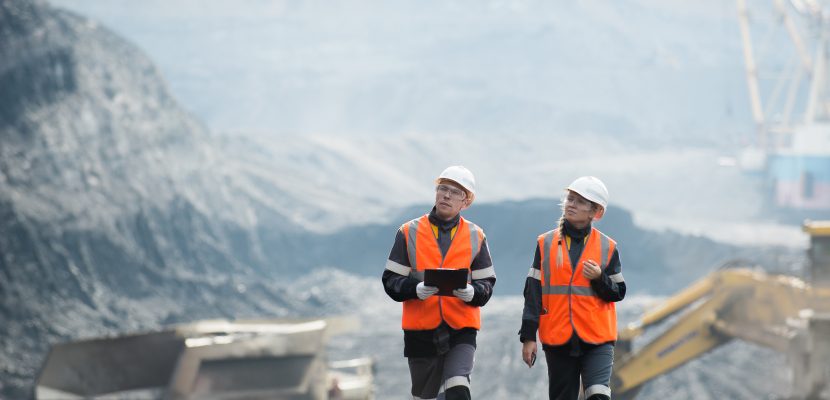 Two speacialists examining coal at an open pit